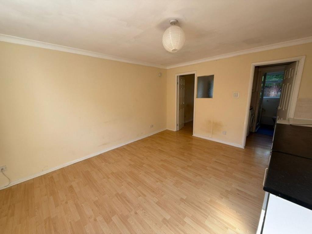 Lot: 121 - GROUND FLOOR APARTMENT FOR IMPROVEMENT - Living room view showing access to bedroom and kitchenette